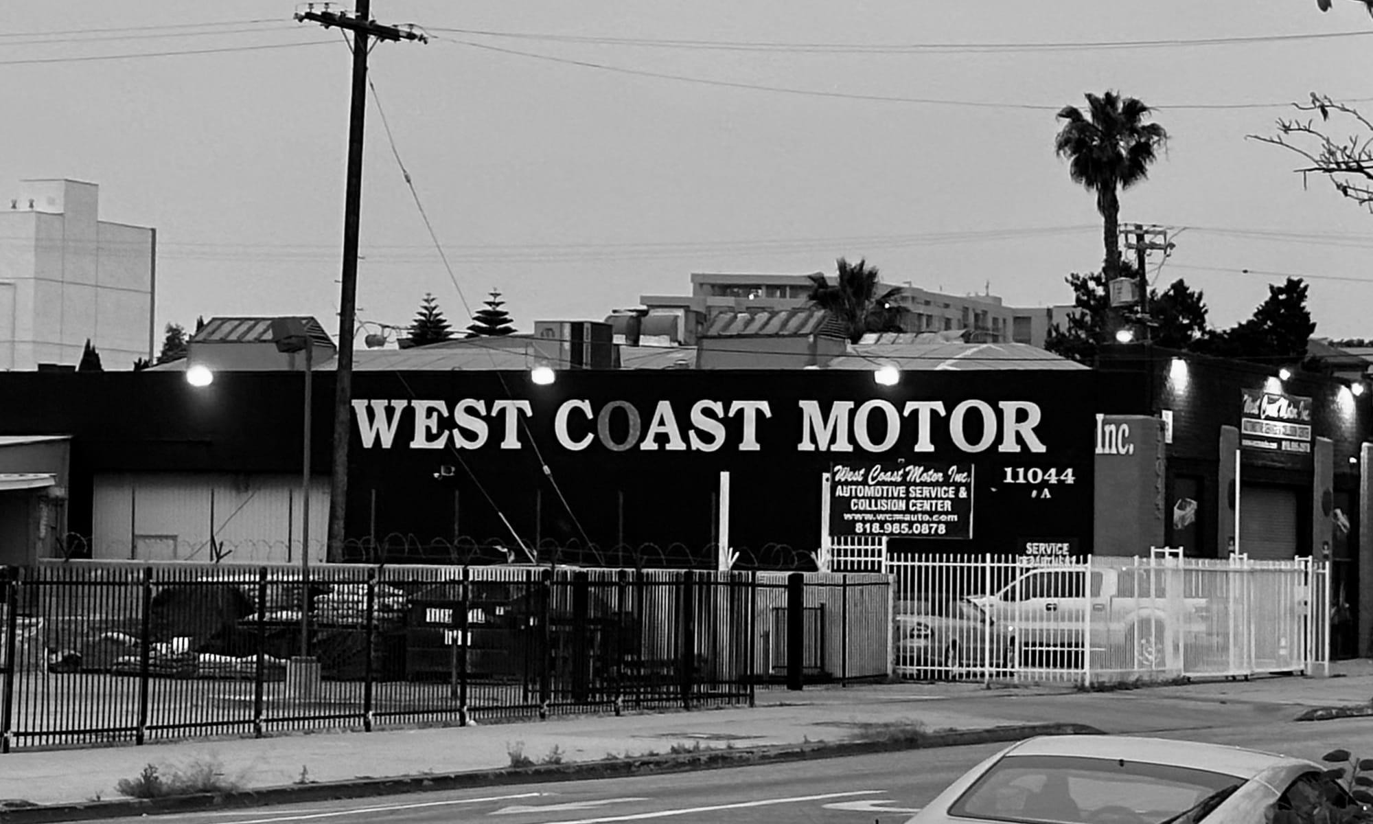 Image of an automotive business in California, showcasing workers and apprentices engaged in vehicle repair and maintenance.